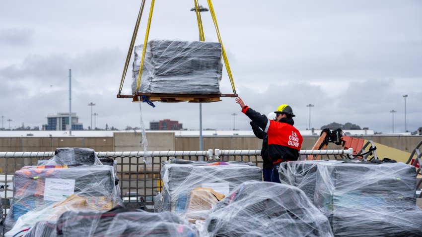 U.S. Coast Guard Cutter Waesche (WMSL 751) crewmembers offload bales of seized narcotics in San Diego, Feb. 13, 2025. The drugs, worth an estimated $275 million, were seized in international waters of the Eastern Pacific Ocean